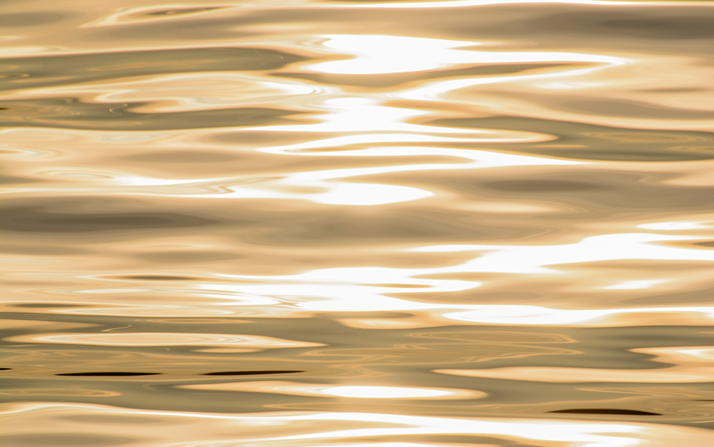 Painting of water surface in gold, black and white