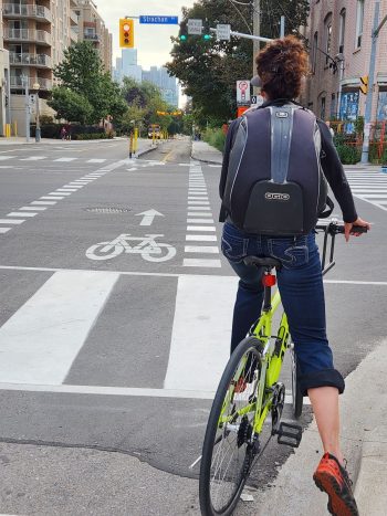 A cyclist on a bike at an intersection waiting for the bike interval to change to green