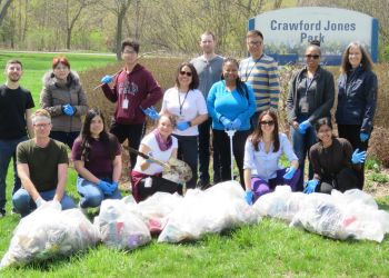 A group of people with litter bags cleaning up Crawford Jones Park for the annual City cleanup.