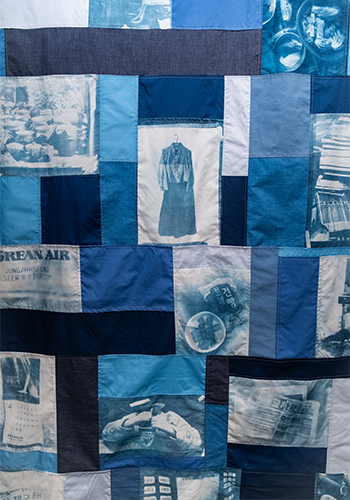 Textile collage of different blue coloured fabric, some printed with images.
