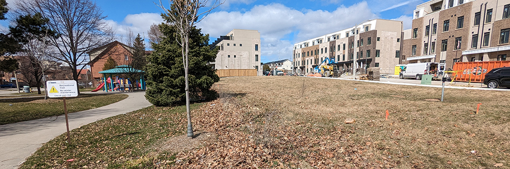 Bartley Park showing an open area on the right side parallel to the new townhouse development under construction and to the existing park pathway on the left.