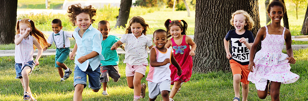 Children running across grass