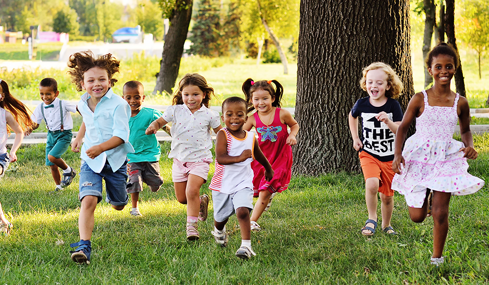 Group of children running across grass