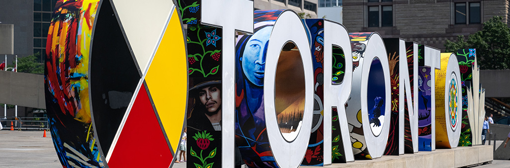 Close up side angle of the TORONTO Sign featuring Indigenous Artwork wrapped around the letters.