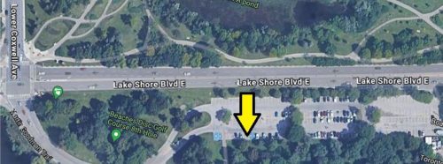 Satellite map of parking lot located at the south east corner of Lower Coxwell Avenue and Lake Shore Boulevard East with graphic arrow point to bottom middle section of the parking lot.