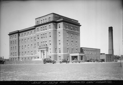 Image depicts monochrome photograph of exterior of hospital building