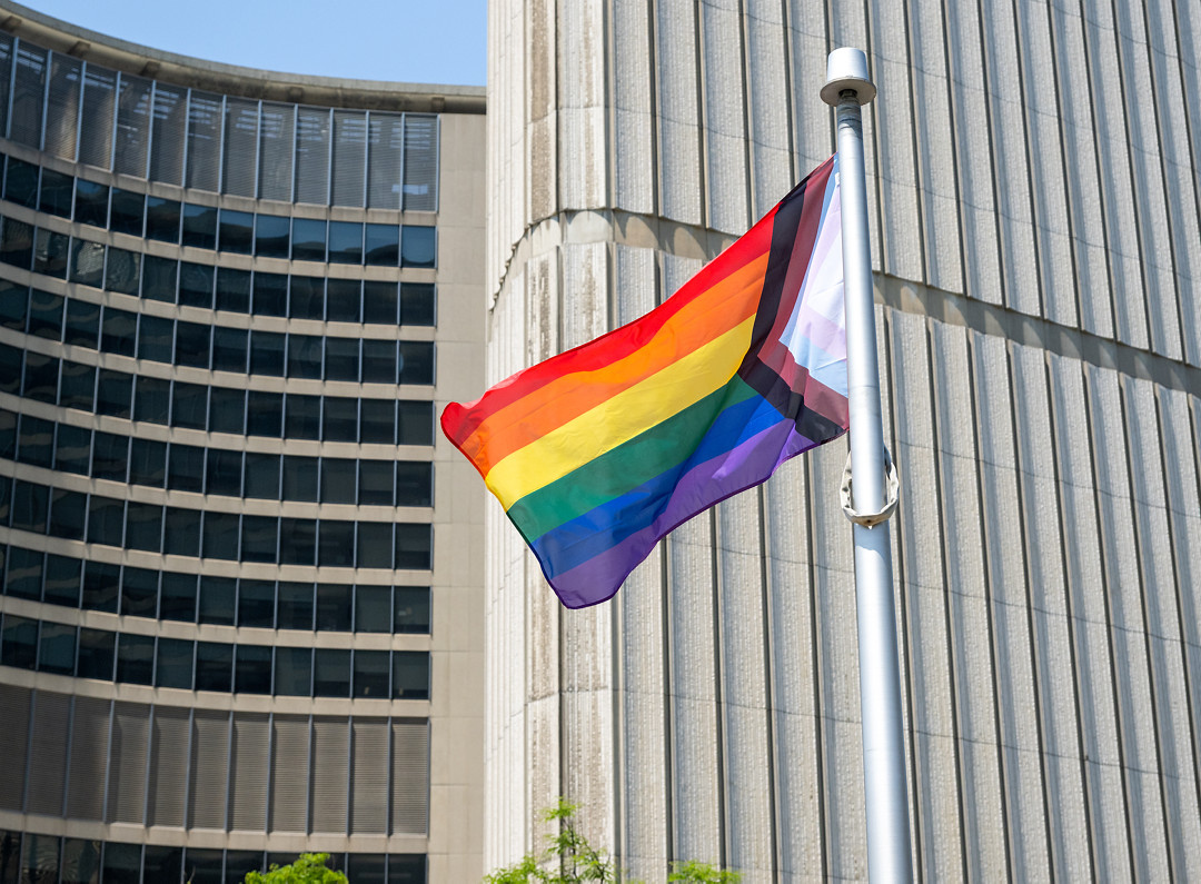 Close up of the Progress Pride flag flying at Toronto City Hall