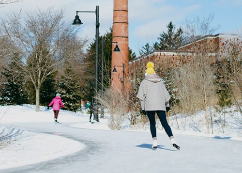 People are skating at the Colonel Samuel Smith outdoor ice rink.
