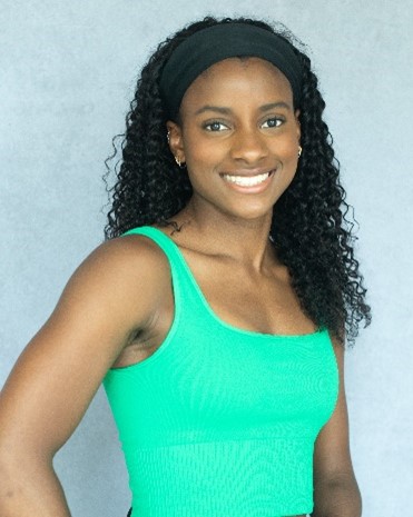 Portrait of Sheriauna Haase smiling in a green top. 