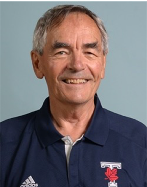 Portrait of Andy Higgins smiling in blue shirt.