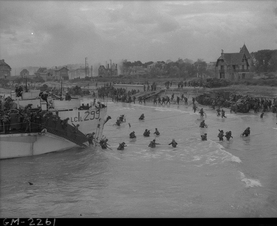 Military troops going ashore from ships, landing on the beach