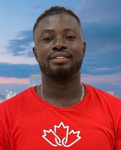 Portrait of Franck Koffi in a red shirt smiling.