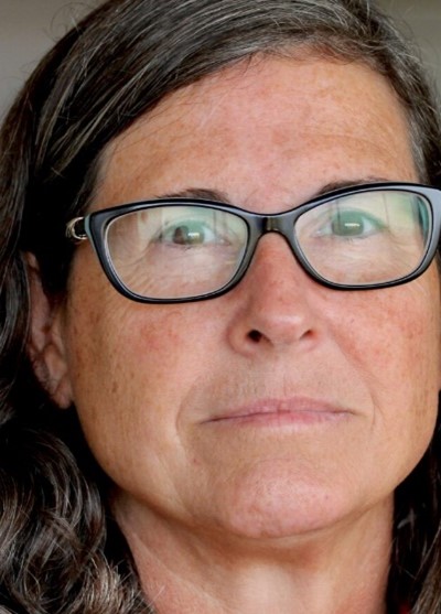 Close up portrait of Vicki Keith wearing glasses.