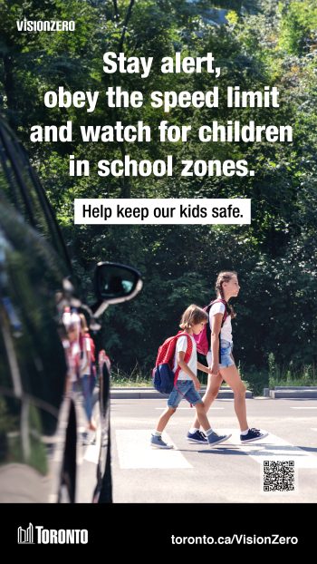 Image of two school children crossing the road.