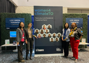 Four Women4ClimateTO participants standing in front of a Women4ClimateTO poster with the Toronto and Live Green logos.