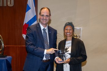 Toronto City Manager poses with Nicole Watson receiving an award.
