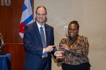 Toronto City Manager poses with Ashley Tulle-Foster receiving an award.