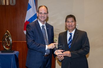 Toronto City Manager poses with Ian Chin receiving an award.
