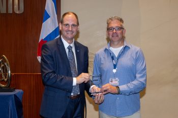 Toronto City Manager poses with Scott Webb receiving an award.