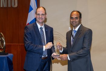 Toronto City Manager poses with Ashley Farias receiving an award.