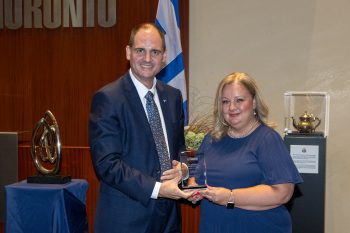 Toronto City Manager poses with Janet Stoeckl receiving an award.