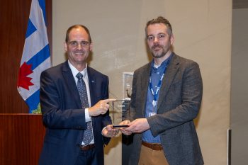 Toronto City Manager poses with Ryan Biava receiving an award.