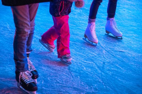 Close up of skates on outdoor rink.
