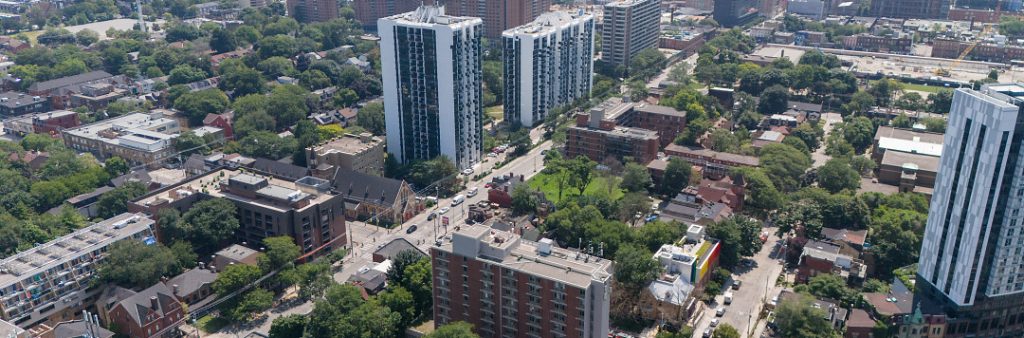Dundas–Sherbourne Neighbourhood scene of park, buildings, and greenhouse.
