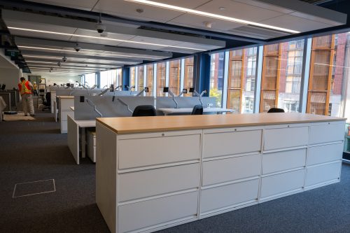 Interior of St Lawrence Market North. Office setting with desks and filing cabinets, looking across the entire floor.