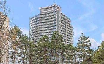 A 21 storey building with trees in the background.