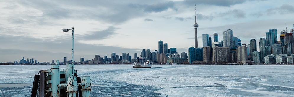 A ferry crossing Toronto’s harbour during the winter from Ward’s Island.