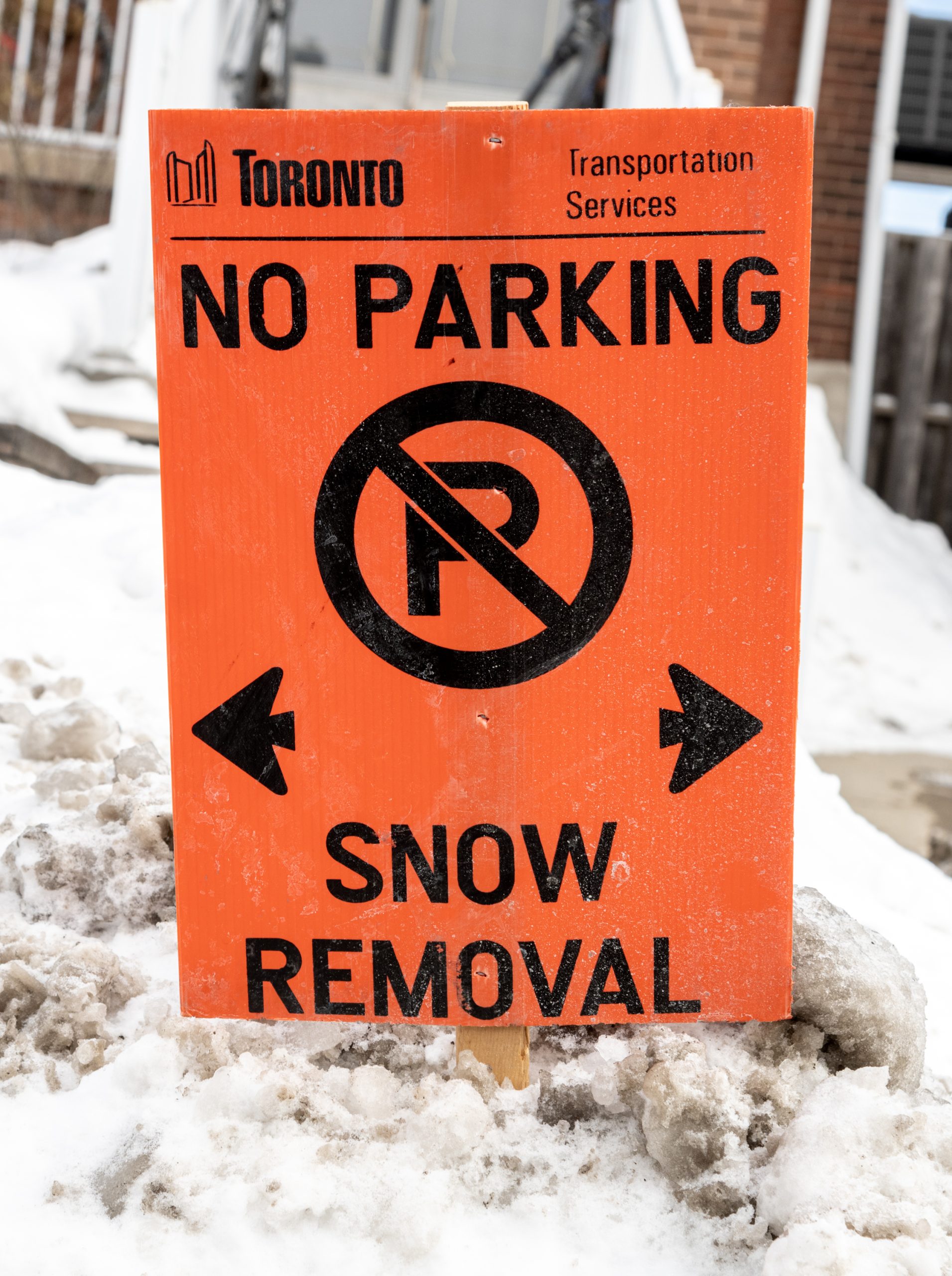 Temporary No Parking - Snow Removal sign in snow bank.