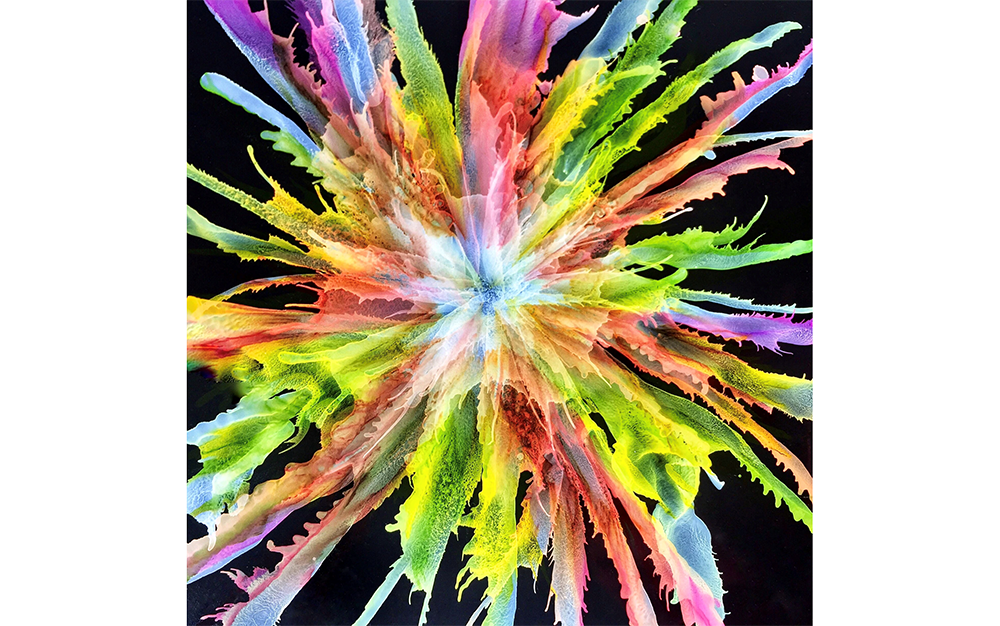 Multicolour splatter on a black background.