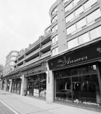 A retail strip with shops at street-level and residential units above.