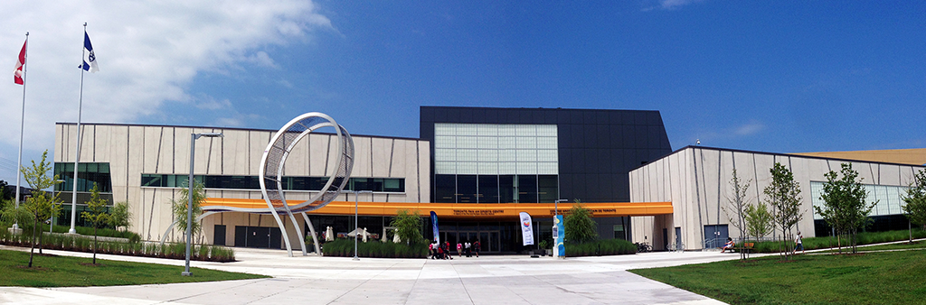 Exterior view of a municipal building with modern architecture including a metal loop shaped sculpture