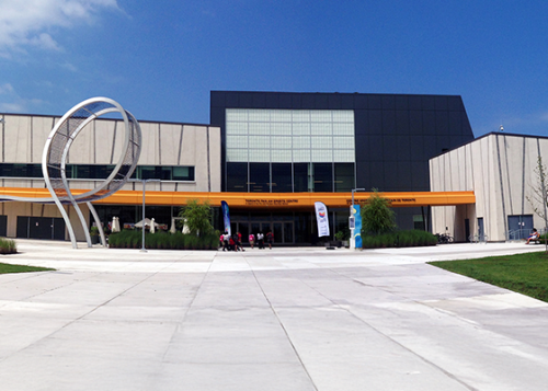 Exterior view of a municipal building with modern architecture including a metal loop shaped design detail