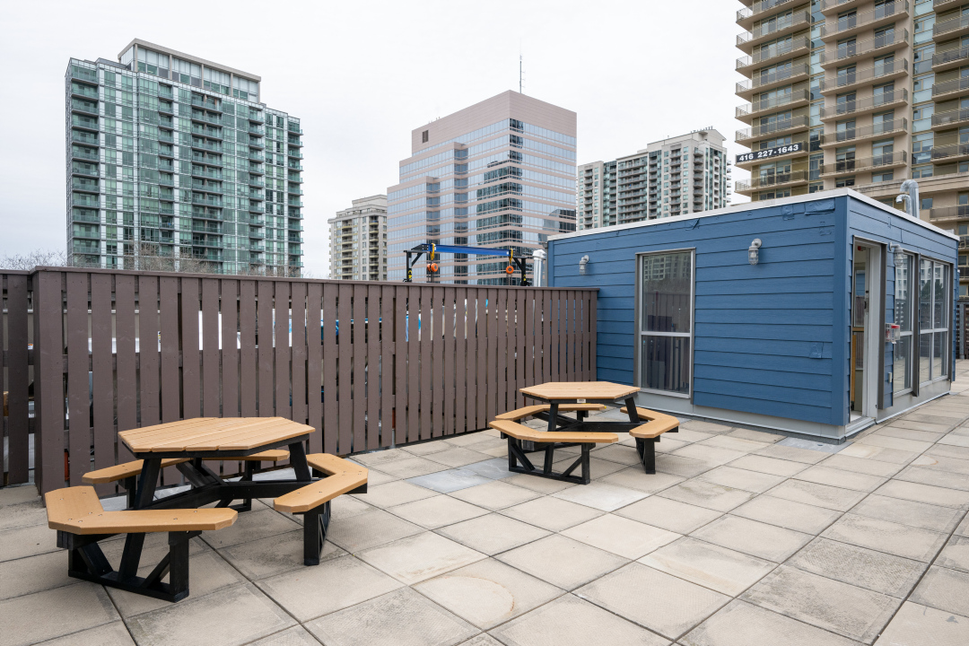 A rooftop patio with picnic tables at 25 Canterbury Place.