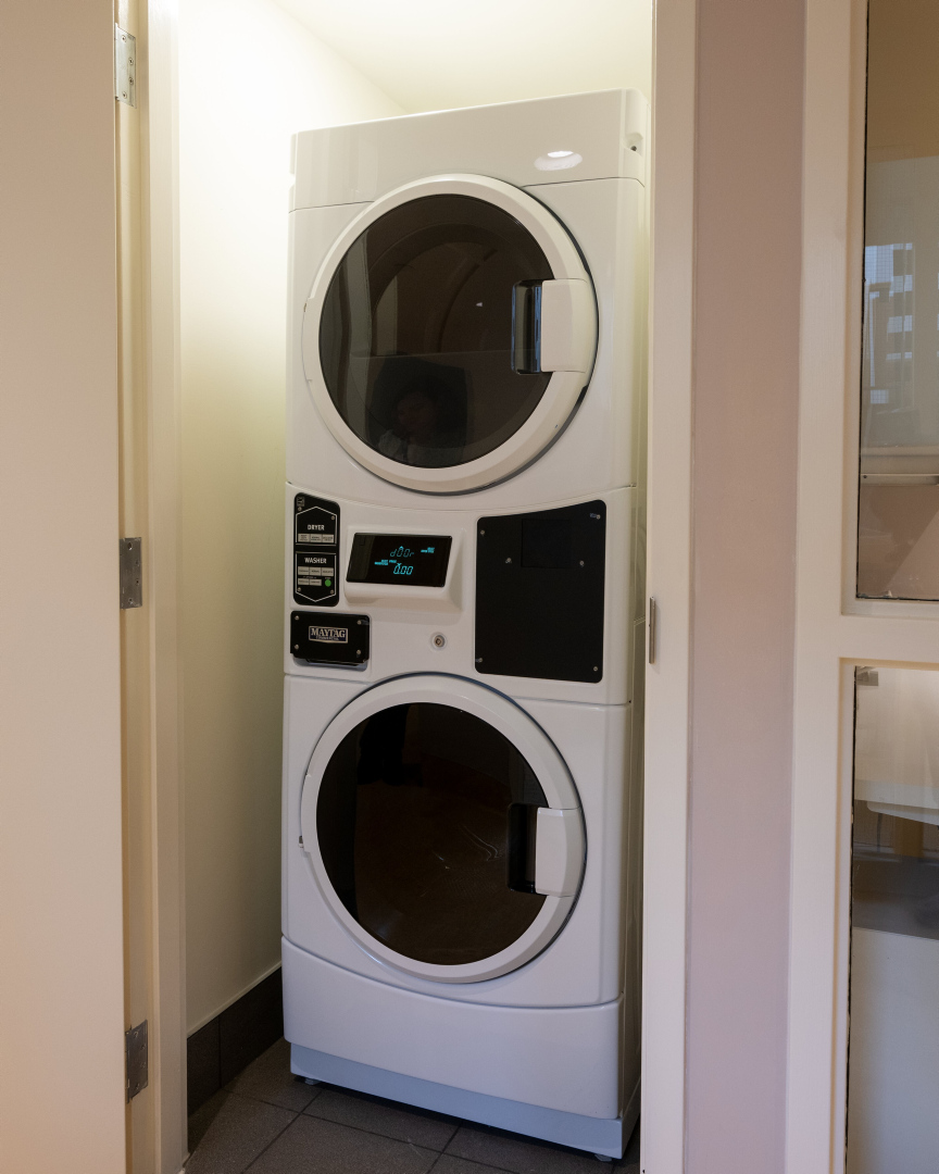 A stacked clothes washer and dryer in the laundry room at 25 Canterbury Place.