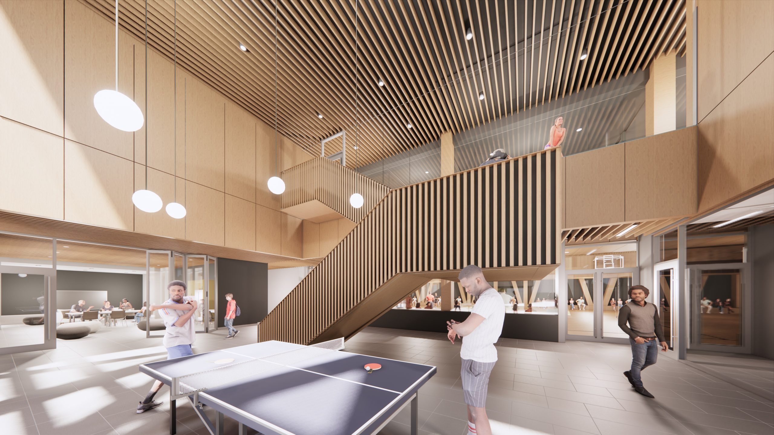 Interior view of the new Lawrence Heights Recreation Centre showing the dedicated youth space, including a lounge with games tables, a staircase to the indoor walking track and views into the gymnasium.