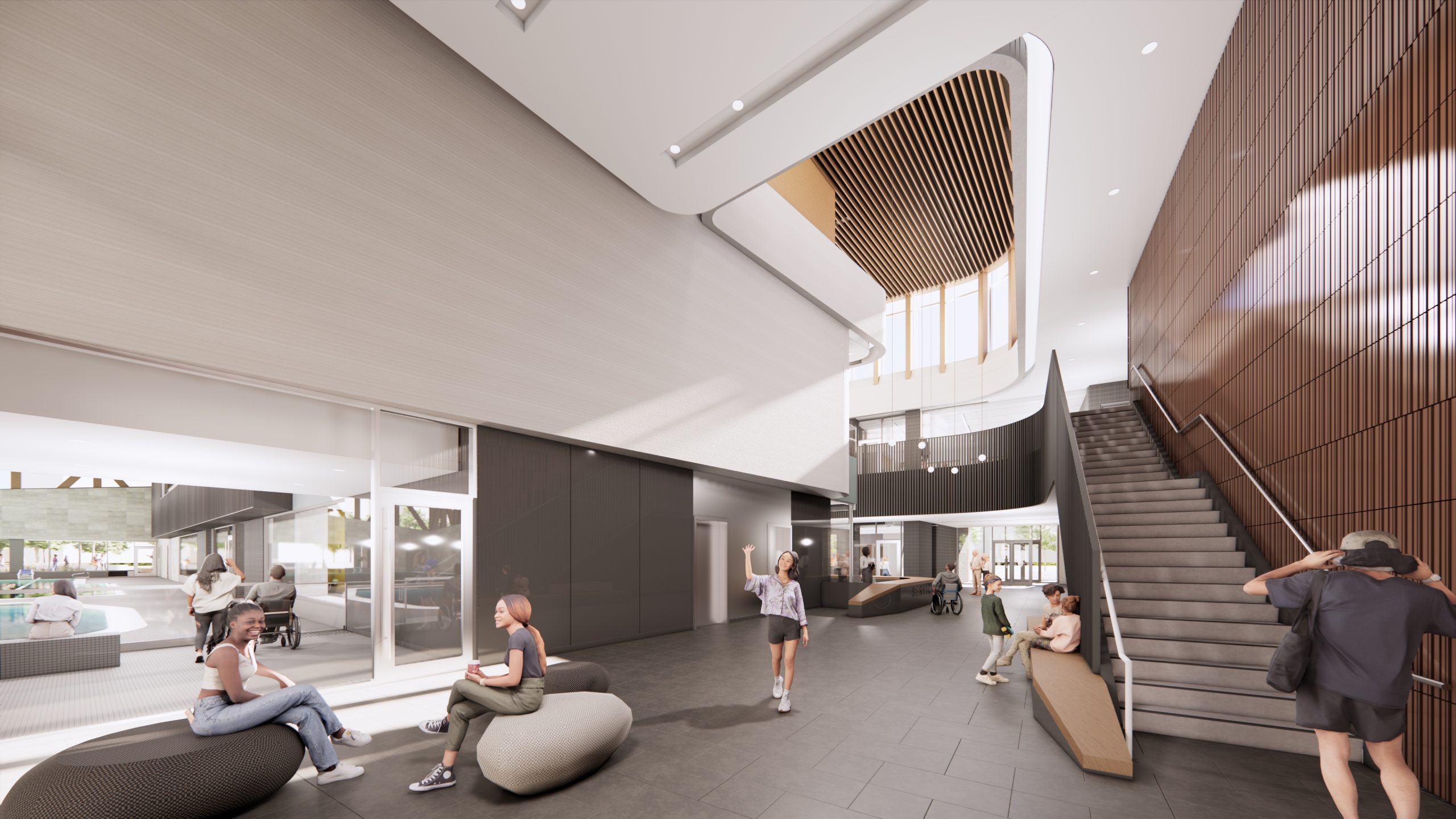Interior view of the new Lawrence Heights Community Recreation Centre showing the main lobby area with views into the aquatics area and a staircase to the second floor.