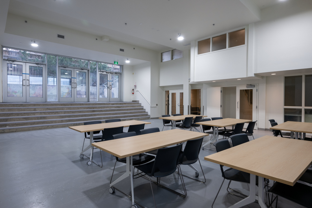 A programming space with tables and chairs at 25 Canterbury Place.