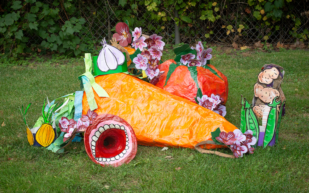 Colourful paper maché sculpture on a grassy field