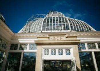 Exterior of Allan Gardens with glass dome and front reading 1909.