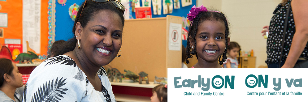 A caregiver and child smiling