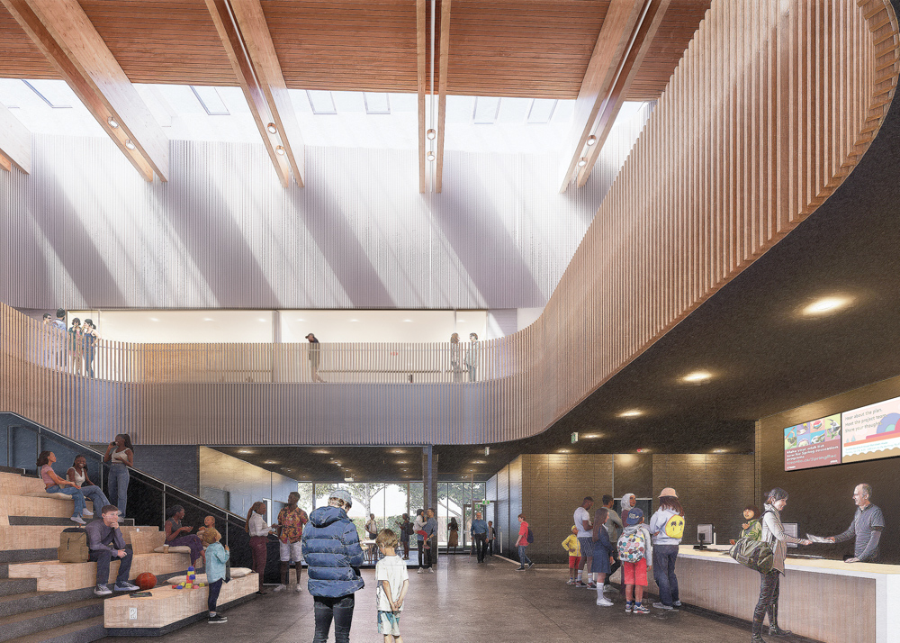 Rendering of the main lobby in the community centre. The open-plan interior has grey floors and masonry walls with wood accents. The left side features bleacher-style seating and steps. The right side features a long reception counter with screens displaying information above. A balcony with vertical wooden slats curves along the second floor. High ceilings with wooden beams and skylights allows natural light through.