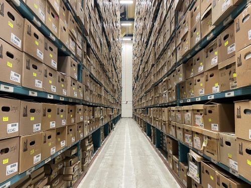 Shelves fully laden with boxes within Toronto Archives Records Centre.