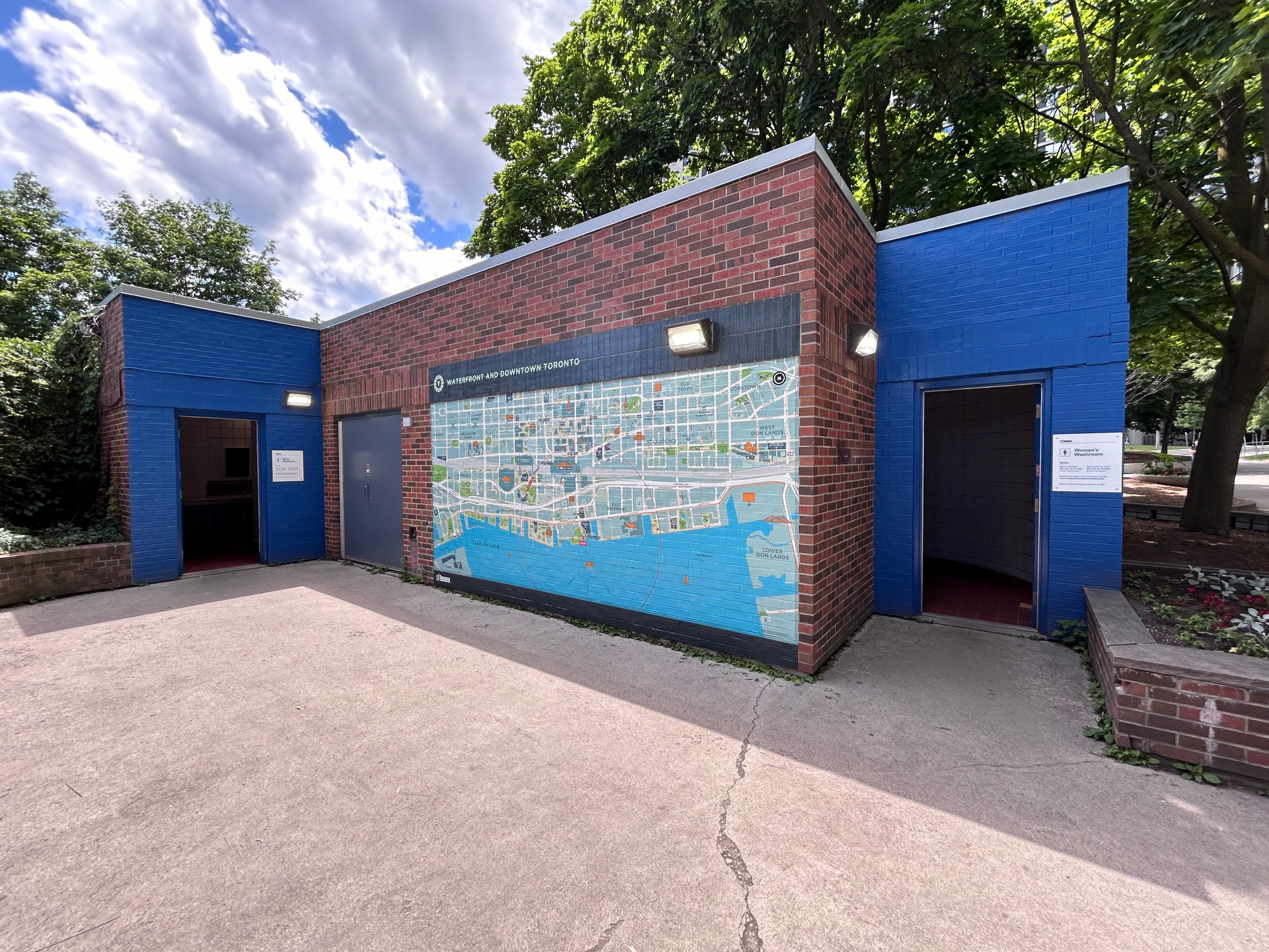One of the brick exterior walls of the washroom building by the exit from Jack Layton Ferry Terminal is covered with the large mural map.