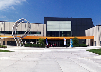 Exterior view of a municipal building with modern architecture including a metal loop shaped sculpture.