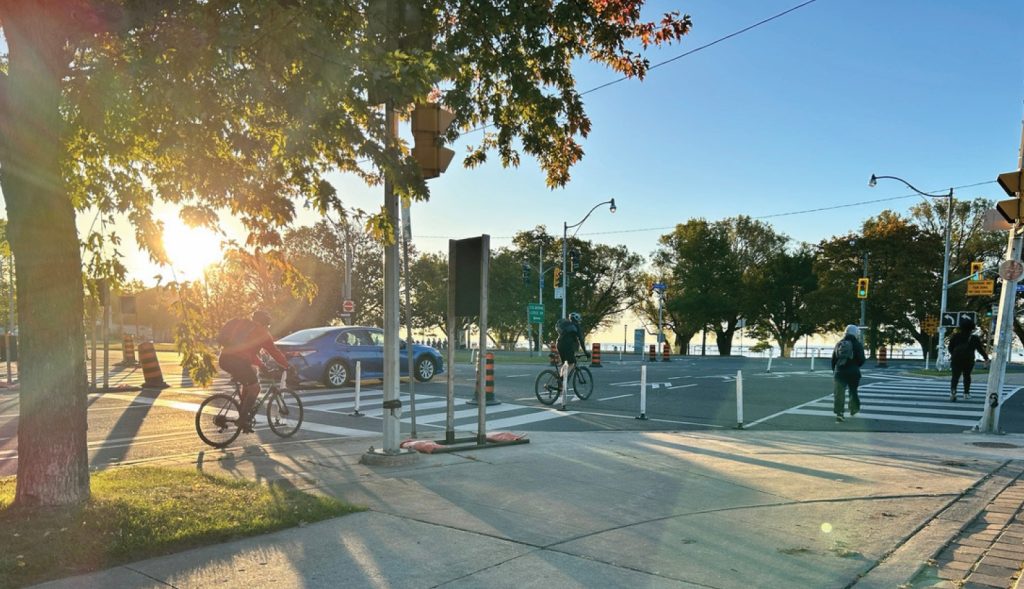 Cyclists and pedestrians moving through a crossing.