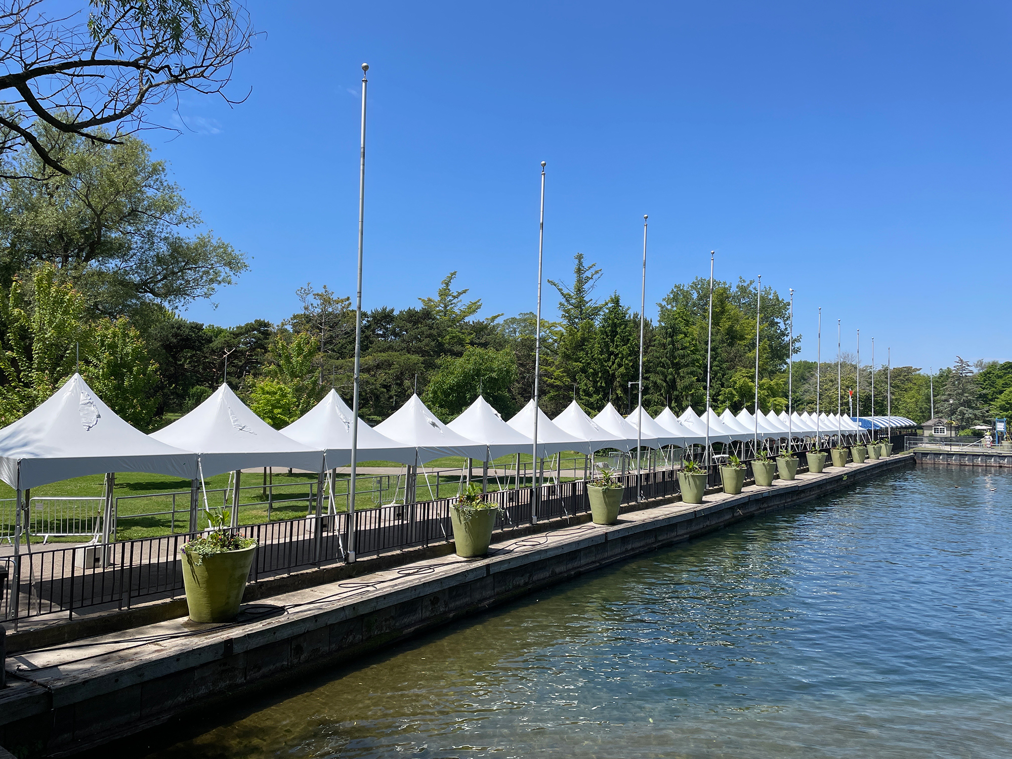 wenty-four white tents line the dock wall at Centre Island dock where passengers gather to take the ferry back to the mainland.